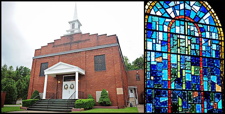 The red brick Second Baptist Church building with a white steeple and columned entrance, beside one of its blue and green stained glass windows